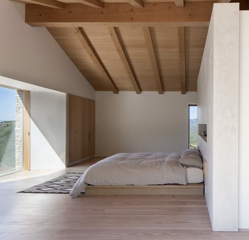 Natural bedroom with oak beams and linen bedding